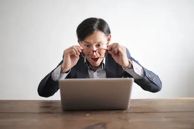 person seeing shocking stories on laptop